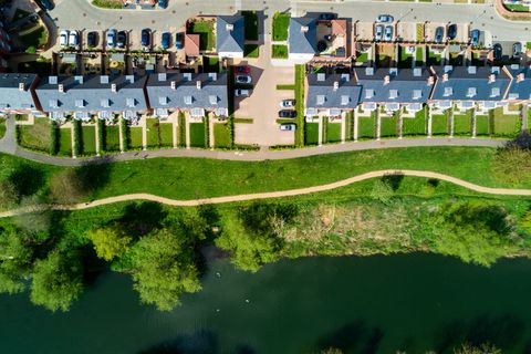 Aerial view of terraced housing beside a river