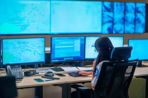 An operator reviews mapping data across control-room screens