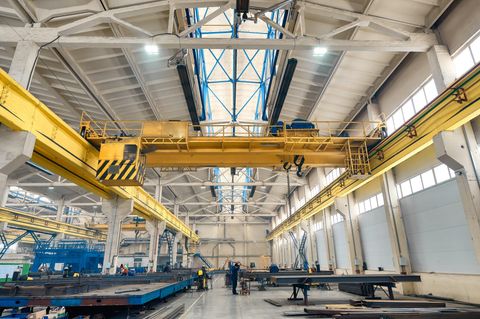 A fabrication hall with overhead cranes above works in progress