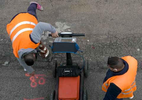 Two operatives carrying out a ground radar survey on a road