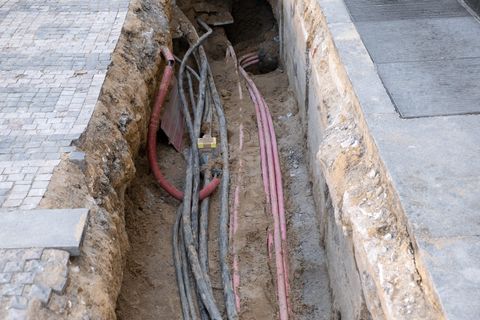 An open street excavation with buried utility services safely exposed