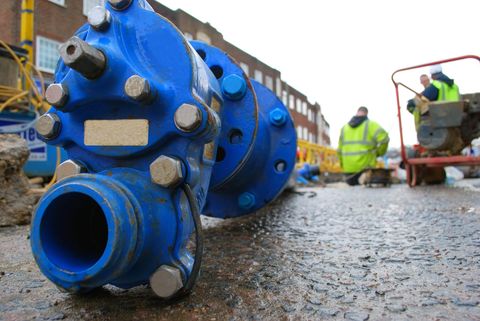 A new blue water main fitting on a street works site