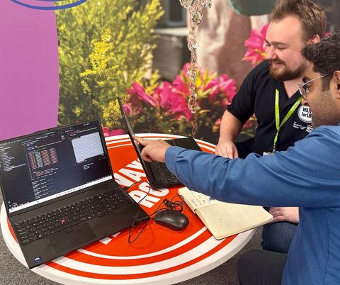 Two RGA engineers working together on laptops